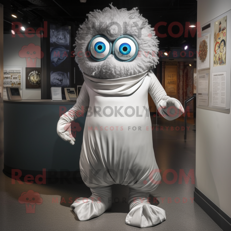 Silver Cyclops mascot costume character dressed with a Wrap Dress and Shoe laces Silver Cyclops mascot costume character dressed with a Wrap Dress and Shoe laces
