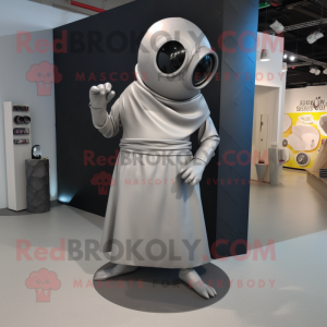 Silver Cyclops mascot costume character dressed with a Wrap Dress and Shoe laces