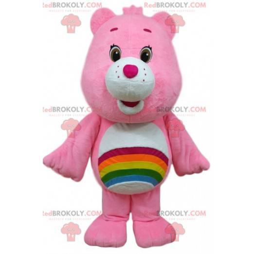 Mascota de oso de cuidado rosa con un arco iris en el estómago.