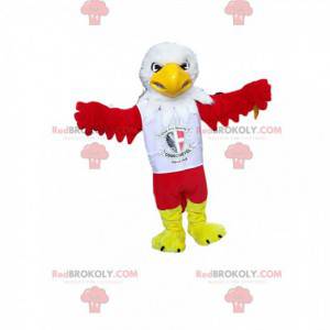 Mascot águila roja con una camiseta de partidario. Disfraz de