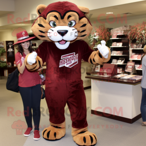 Maroon Saber-Toothed Tiger mascot costume character dressed with a Mom Jeans and Hats