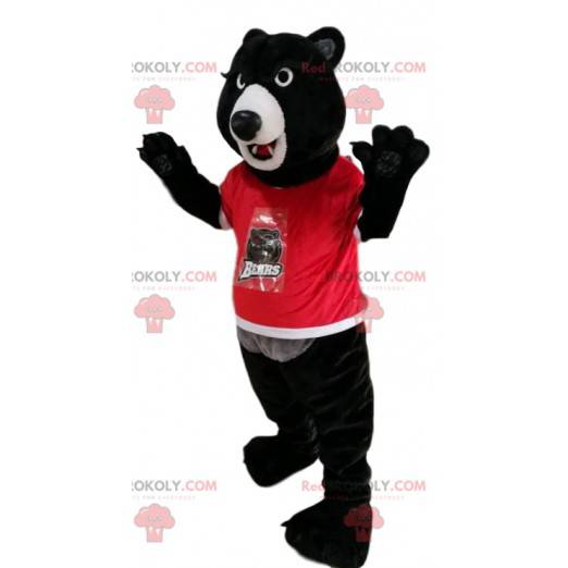 Maskot černého medvěda v červeném dresu. Kostým černého medvěda
