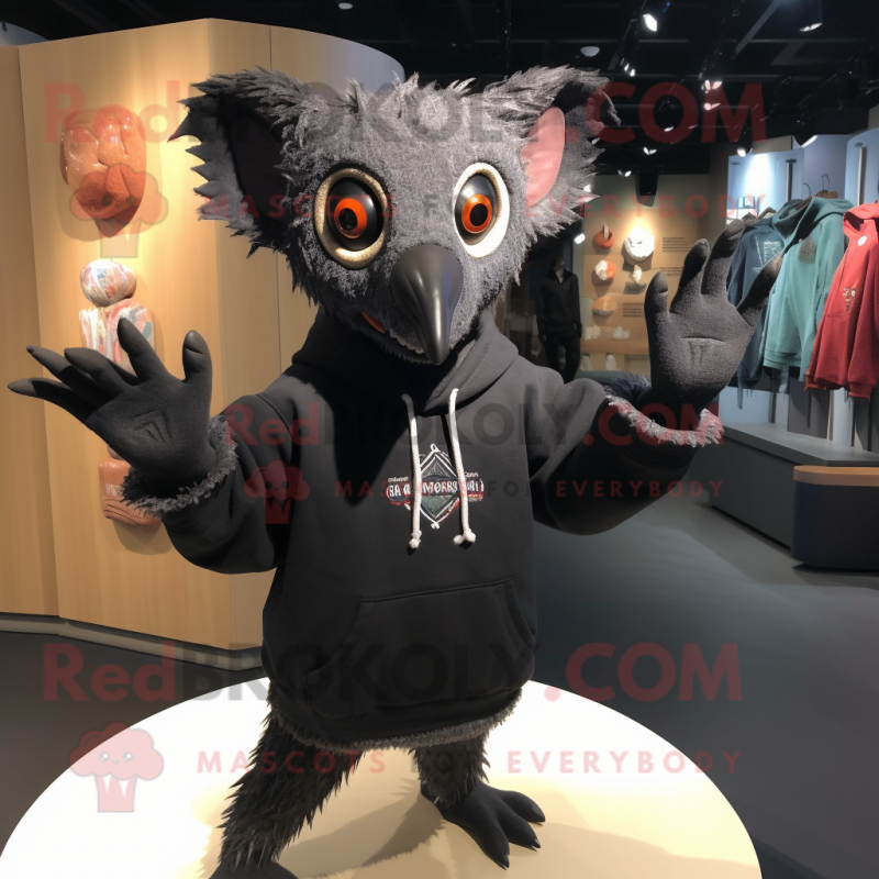 Black Aye-Aye mascot costume character dressed with a Sweatshirt and Shawl pins