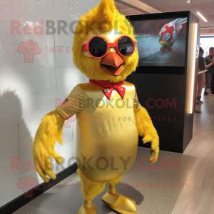 Gold Chicken mascot costume character dressed with a Rash Guard and Hair clips