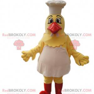 Mascota de pollo amarillo con delantal y gorro de cocinero. -