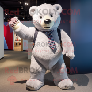 Silver Bear mascot costume character dressed with a Oxford Shirt and Clutch bags