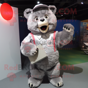 Silver Bear mascot costume character dressed with a Oxford Shirt and Clutch bags