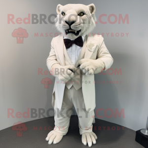 White Smilodon mascot costume character dressed with a Empire Waist Dress and Bow ties