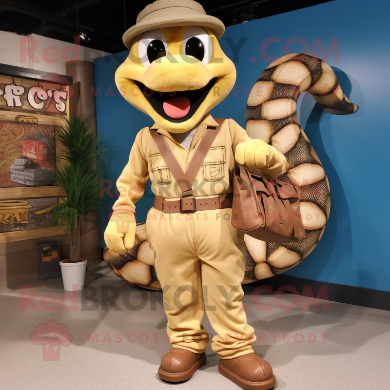 Tan Python mascot costume character dressed with a Dungarees and Handbags Tan Python mascot costume character dressed with a Dungarees and Handbags