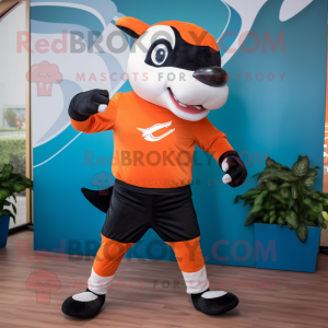 Orange Killer Whale mascot costume character dressed with a Running Shorts and Headbands