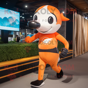 Orange Killer Whale mascot costume character dressed with a Running Shorts and Headbands