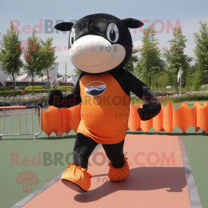 Orange Killer Whale mascot costume character dressed with a Running Shorts and Headbands