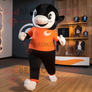 Orange Killer Whale mascot costume character dressed with a Running Shorts and Headbands