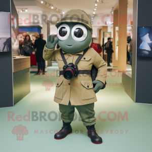 Olive Camera mascot costume character dressed with a Jacket and Briefcases