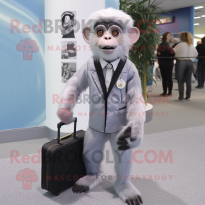 Silver Capuchin Monkey mascot costume character dressed with a Suit Jacket and Messenger bags