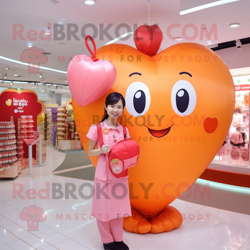 Peach Heart Shaped Balloons mascot costume character dressed with a Henley Shirt and Coin purses Peach Heart Shaped Balloons mascot costume character dressed with a Henley Shirt and Coin purses