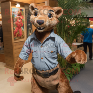 Brown Jaguarundi mascot costume character dressed with a Chambray Shirt and Shoe clips