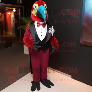 Maroon Macaw mascot costume character dressed with a Tuxedo and Tie pins