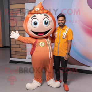 Peach Tikka Masala mascot costume character dressed with a Overalls and Rings
