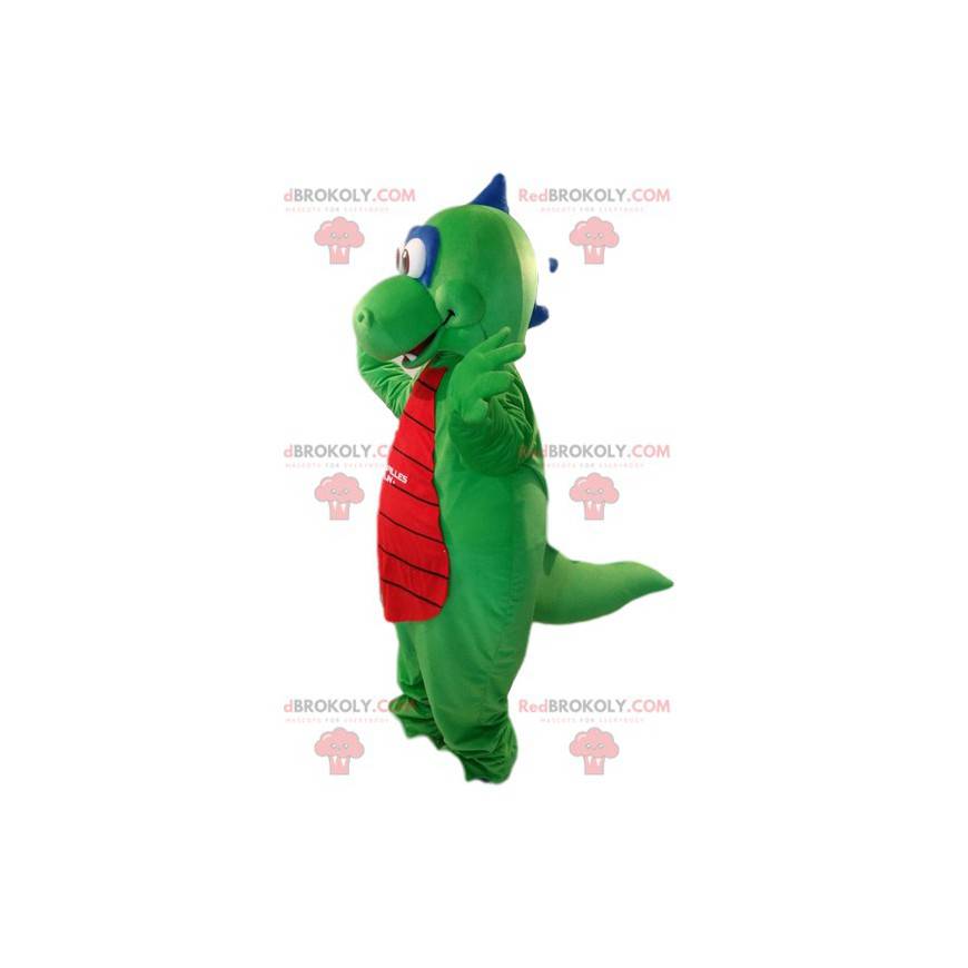 Mascotte de dragon vert et rouge très souriant. Costume de