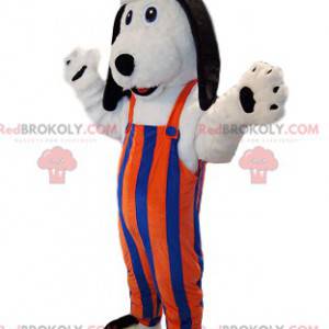 Witte hond mascotte met oranje en blauw gestreepte overall. -