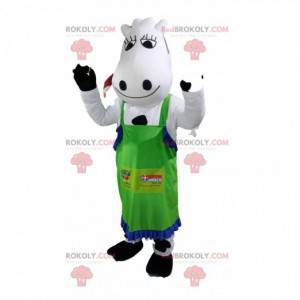 Mascotte de vache blanche et noire avec un tablier vert. -