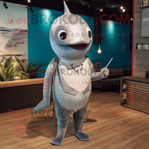 Silver Narwhal mascot costume character dressed with a Board Shorts and Tie pins