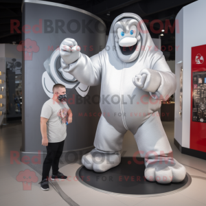 Silver Strongman mascot costume character dressed with a Hoodie and Watches