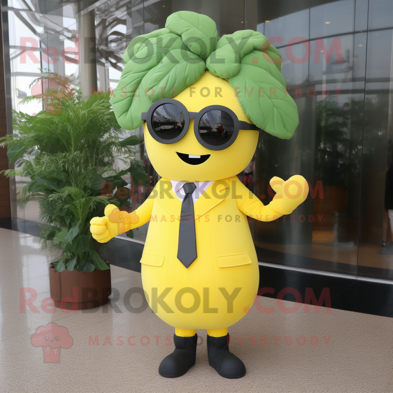 Yellow Spinach mascot costume character dressed with a Suit and Sunglasses