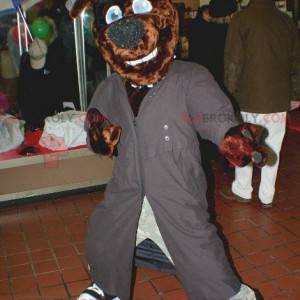 Brown dog mascot with a long gray coat and a hat -