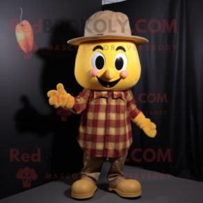 Gold Cherry mascot costume character dressed with a Flannel Shirt and Hat pins