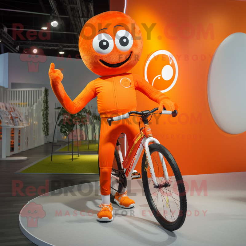 Orange Unicyclist mascot costume character dressed with a Running Shorts and Gloves