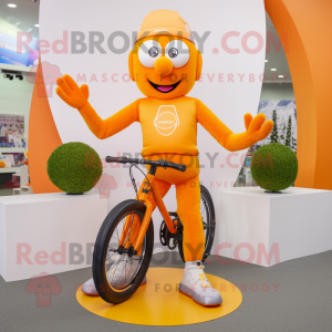 Orange Unicyclist mascot costume character dressed with a Running Shorts and Gloves