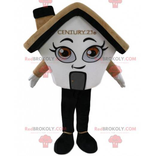 Mascotte de maison crème et blanche, avec une cheminée -