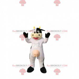 Mascot vaca blanca y negra, con cuernos amarillos. -