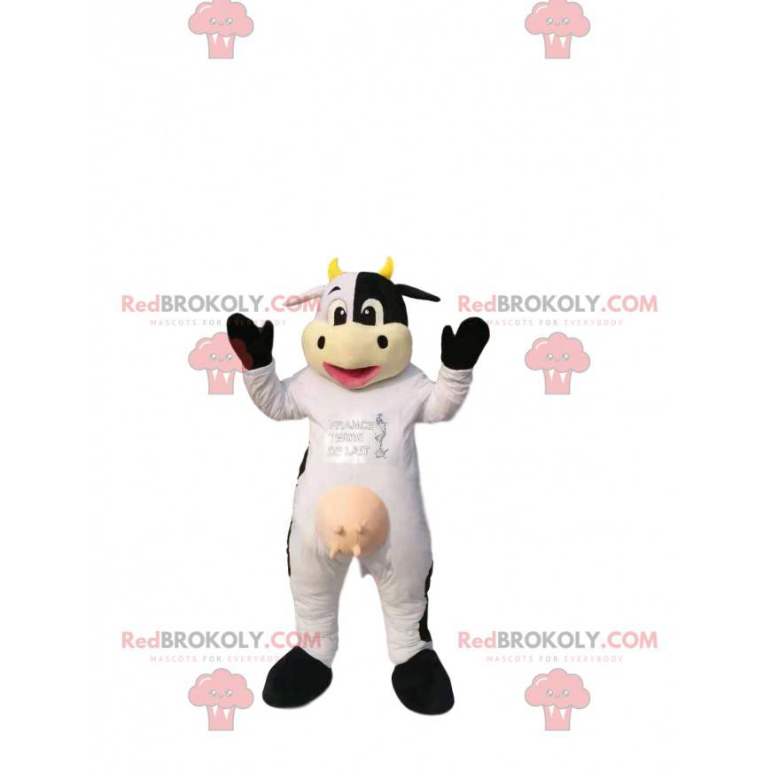 Vaca mascote branca e preta, com chifres amarelos. -