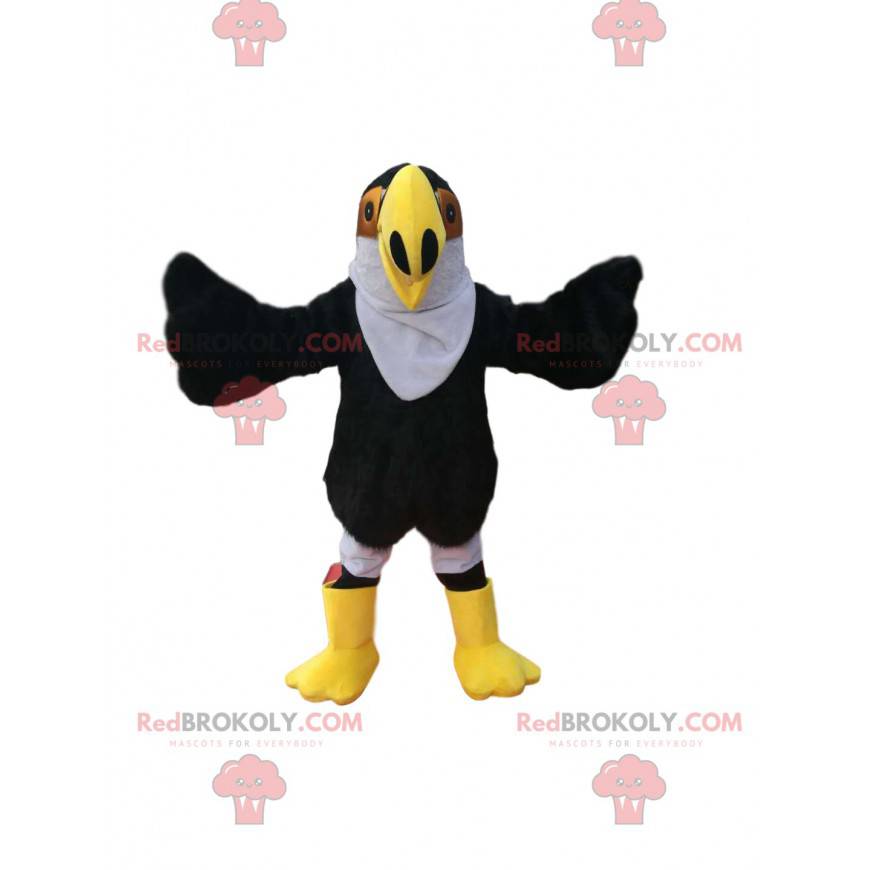 Mascotte d'aigle noir avec un grand bec jaune. Costume d'aigle Mascotte d'aigle noir avec un grand bec jaune. Costume d'aigle