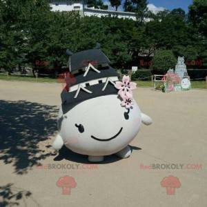 Mascot all round and smiling with a roof on the head -