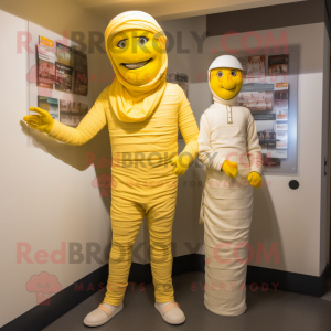 Lemon Yellow Mummy mascot costume character dressed with a Trousers and Berets