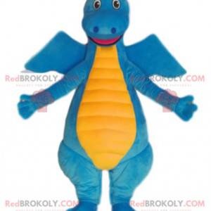 Mascote de dinossauro azul e amarelo muito sorridente. -