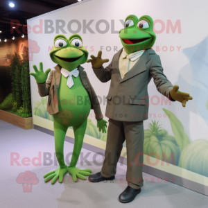 Olive Frog mascot costume character dressed with a Suit Jacket and Watches