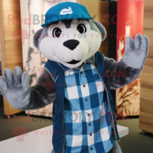 Blue Otter mascot costume character dressed with a Flannel Shirt and Beanies