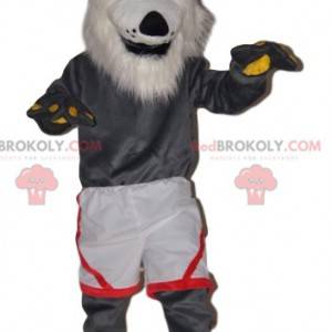 Mascota lobo gris muy alegre con pantalones cortos blancos -