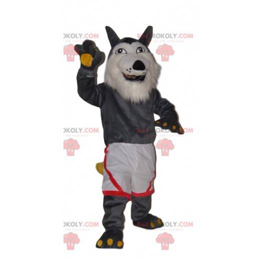 Mascote de lobo cinza muito alegre com shorts brancos -