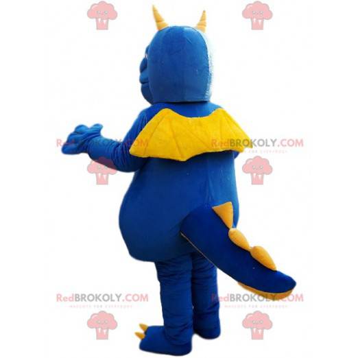 Mascota dragón azul y amarillo con un gran hocico -