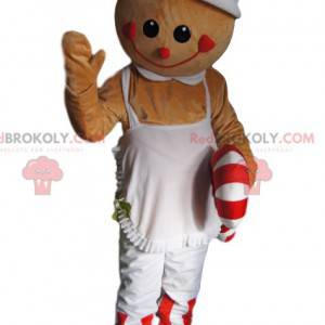 Mascotte de bonhomme beige avec un tablier et un sucre d'orge -