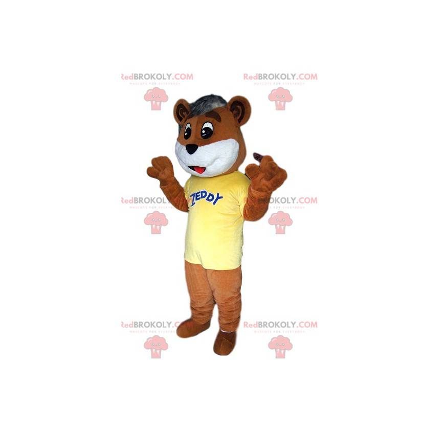 Mascota de oso pardo tocando, con su camiseta amarilla -