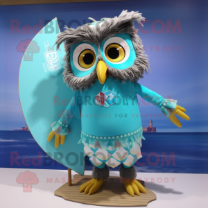 Turquoise Owl mascot costume character dressed with a Board Shorts and Hairpins