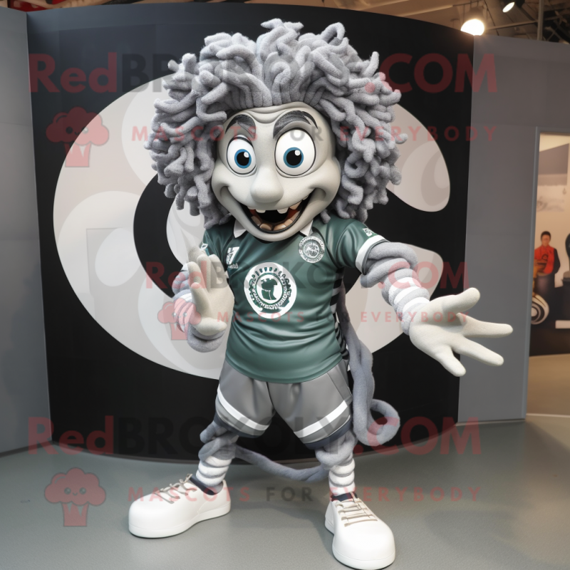 Silver Medusa mascot costume character dressed with a Rugby Shirt and Rings