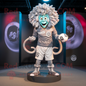 Silver Medusa mascot costume character dressed with a Rugby Shirt and Rings